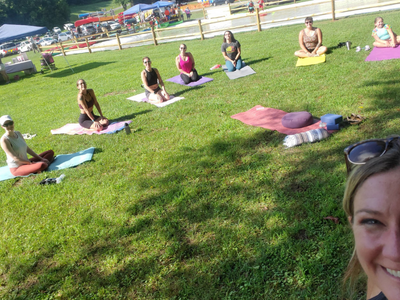 People doing yoga in the grass